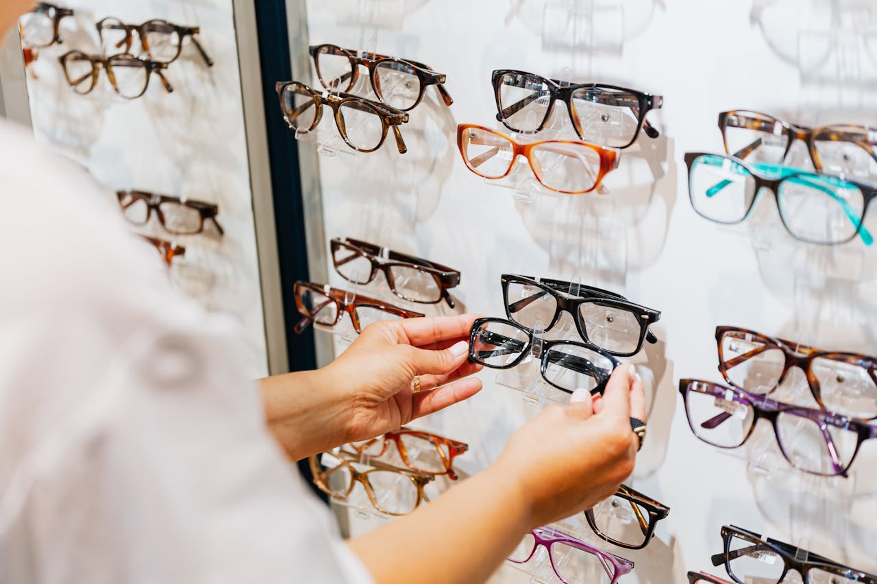 The Art of Drawing Readers In: Your attractive post title goes here Hands selecting glasses from a display wall in an eyewear store.